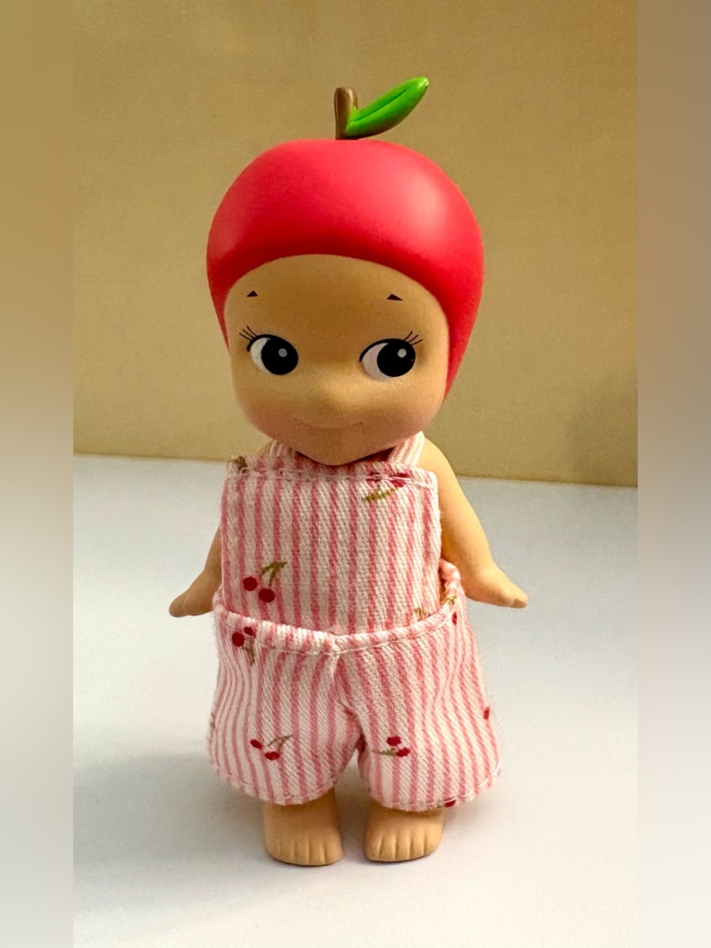 Red Apple from Sonny Angel Fruit series in adorable overalls w/ cherries print.